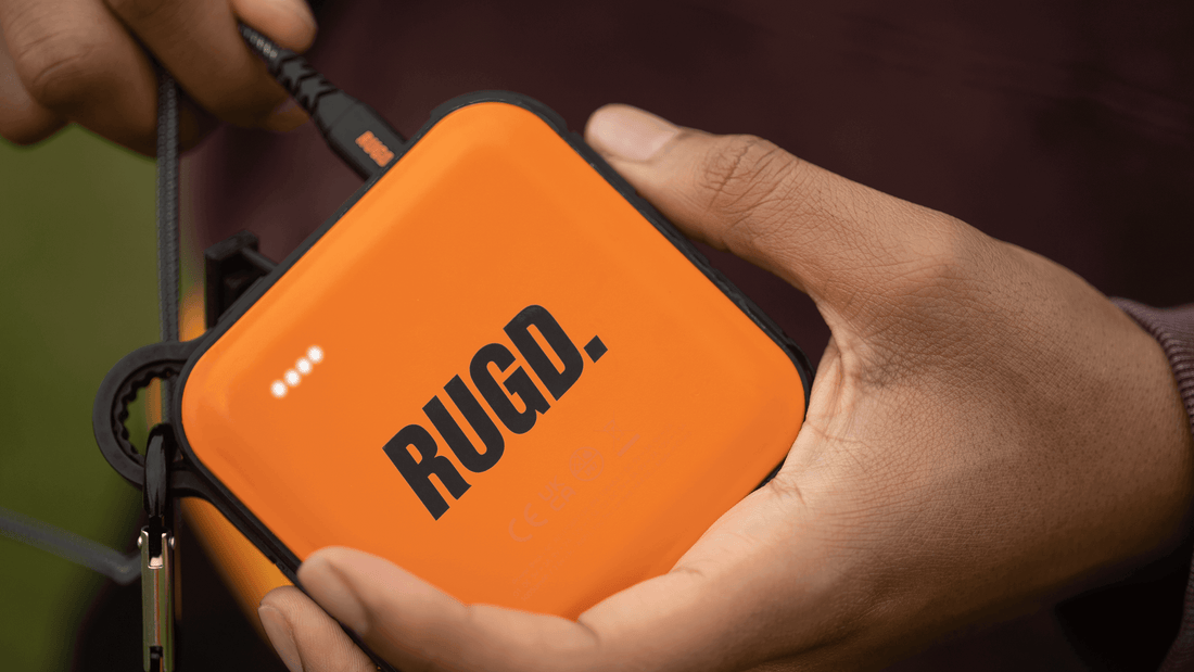 Charging an orange portable power bank for optimal battery life and performance.