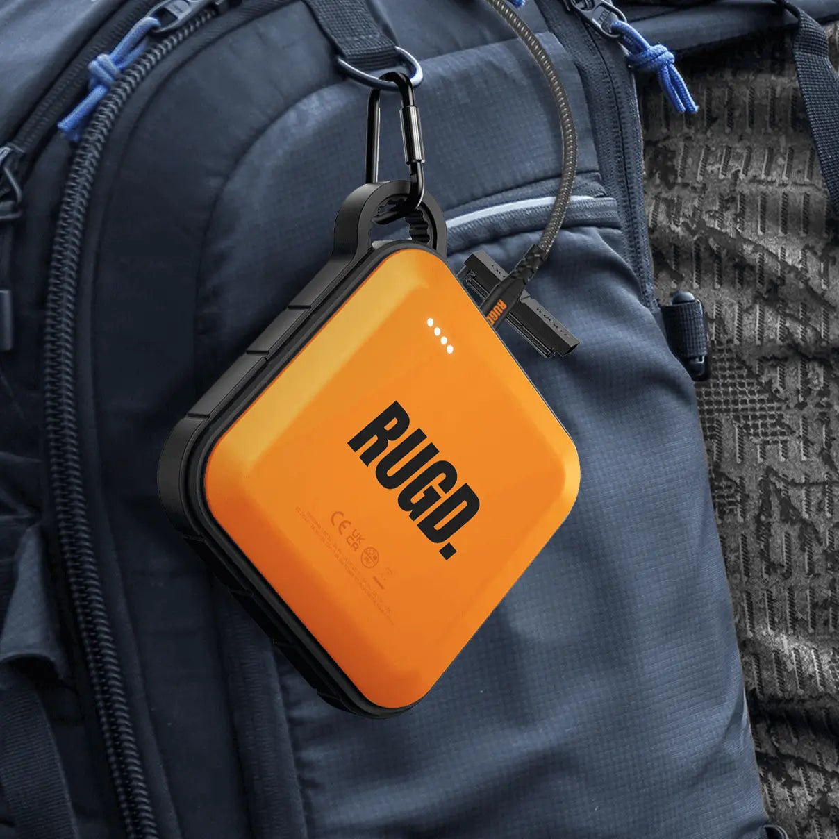 RUGD Power Brick attached to a backpack, showcasing its portability for outdoor adventures.