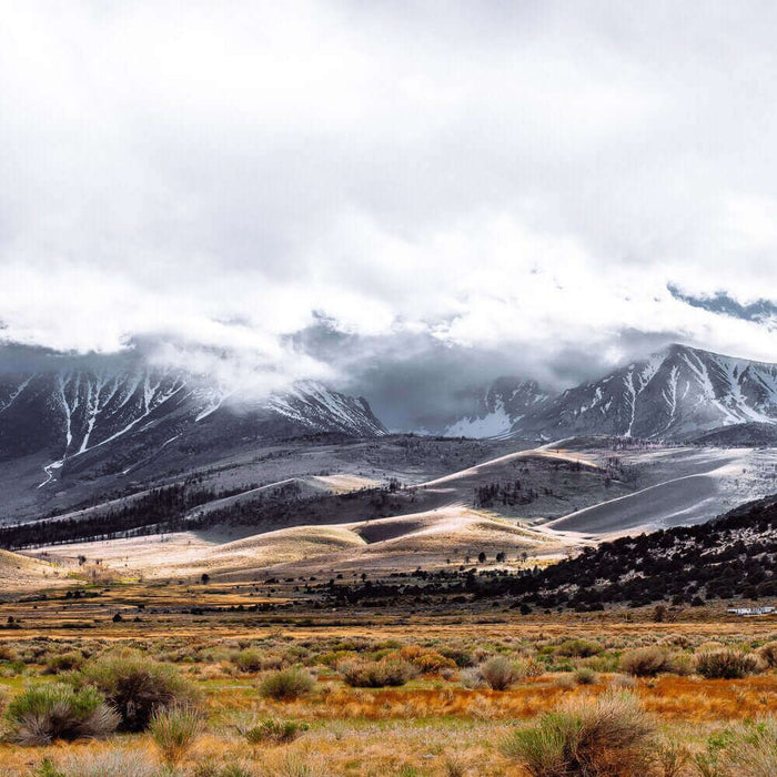 Scenic view of a unique camping destination with snow-capped mountains and valleys