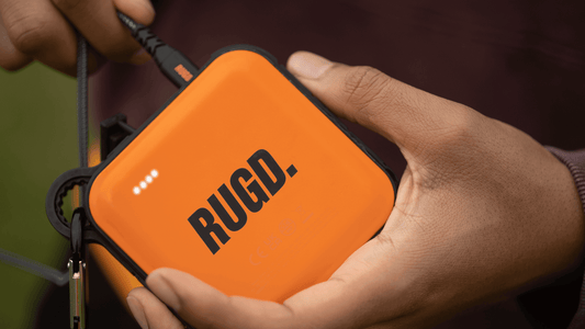 Charging an orange portable power bank for optimal battery life and performance.