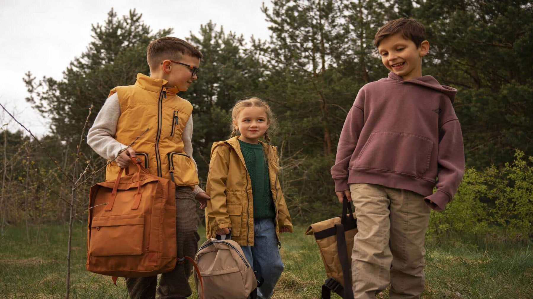 Children happily walking in a forest with camping gear, illustrating a fun and safe family camping trip.