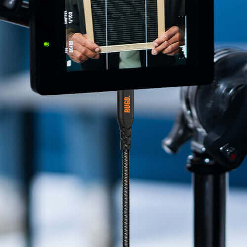 Close-up of a RUGD USB-C to USB-C cable connected to a device during charging