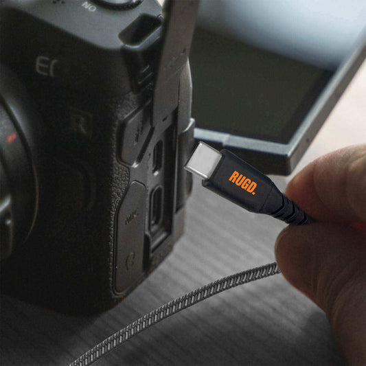 Close-up of a RUGD Rhino Power USB-C to USB-C cable being connected to a camera, showcasing fast charging performance, rugged build, and universal device compatibility.