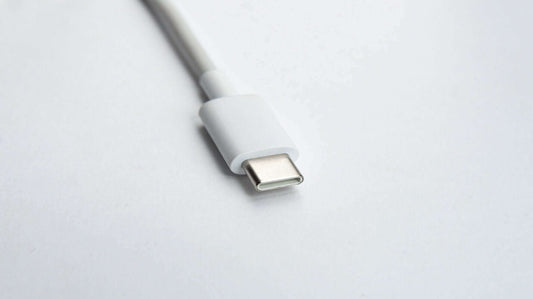 Close-up of a white USB-C cable on a white background.