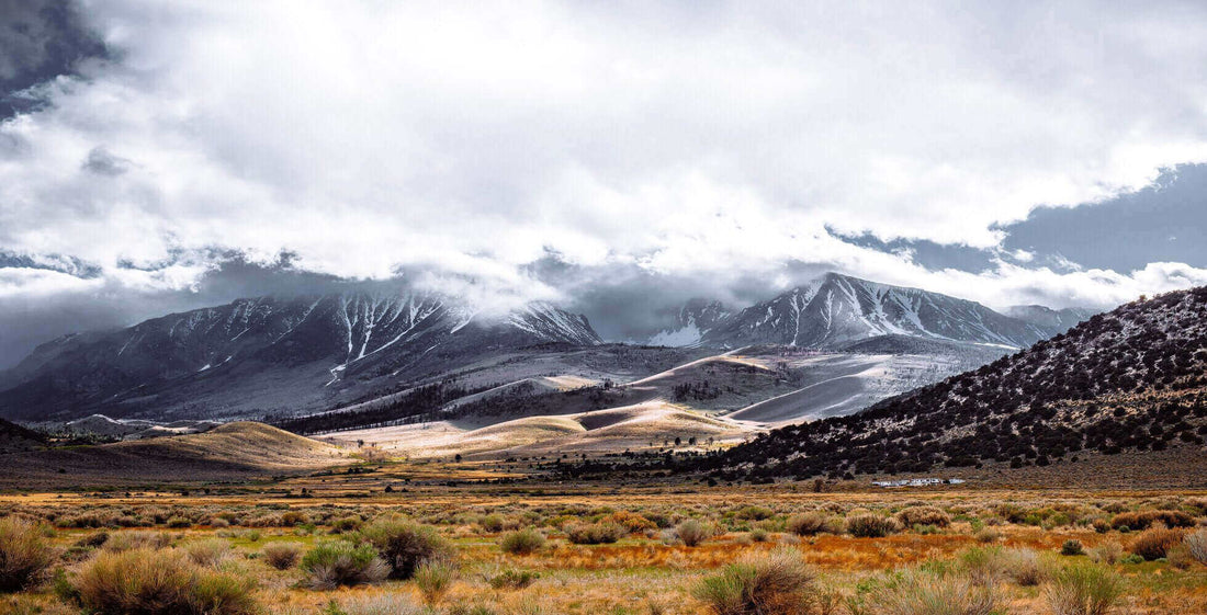 Scenic view of a unique camping destination with snow-capped mountains and valleys