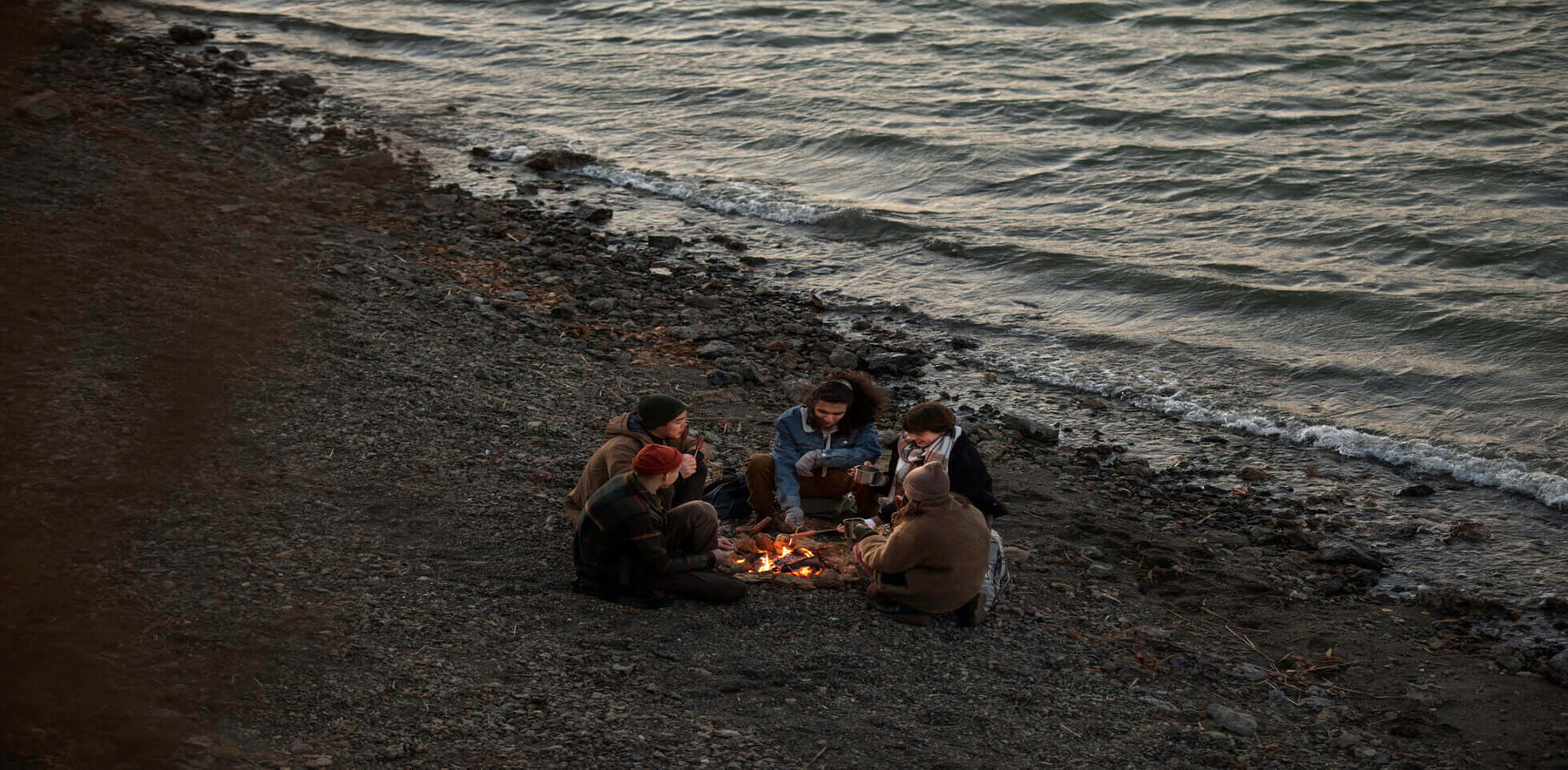 Friends enjoy camping by the beach