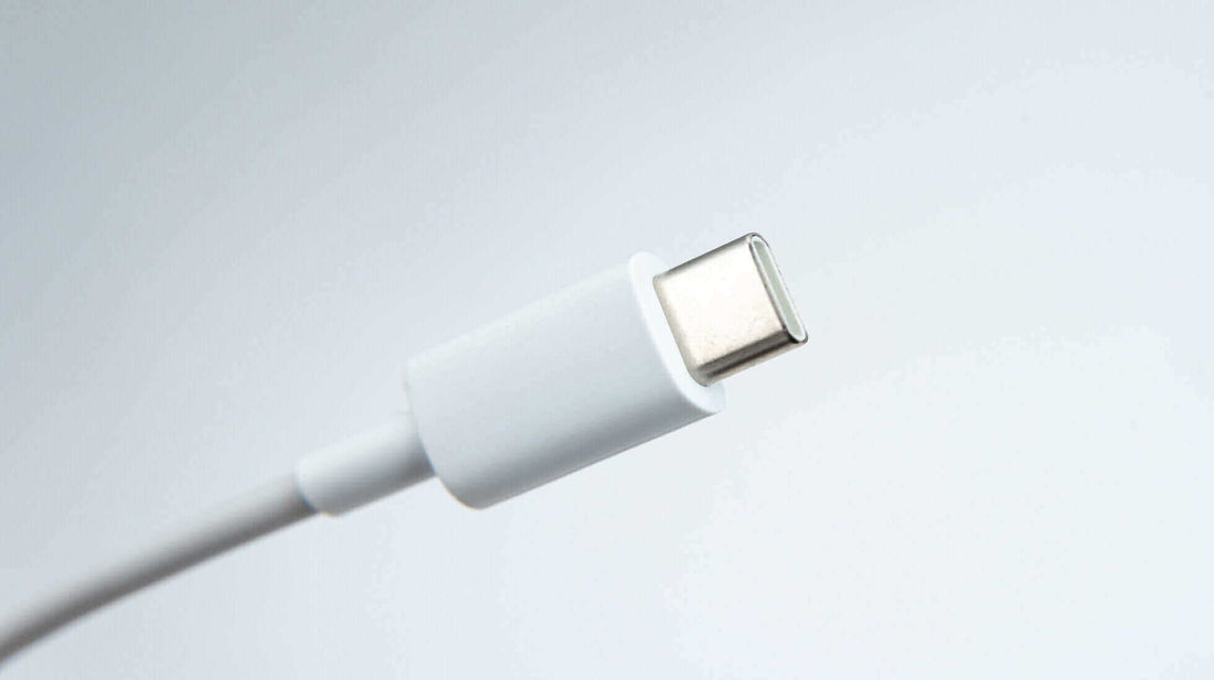 Close-up of a white USB-C cable for power delivery and data transfer.