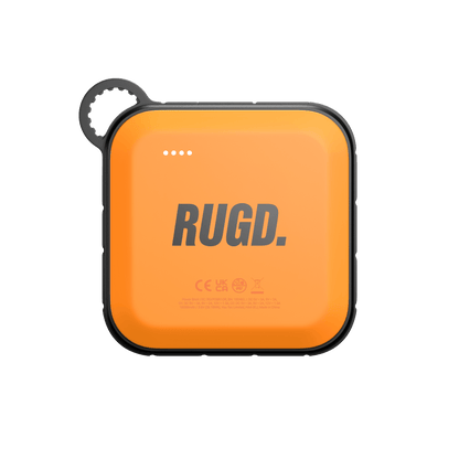 RUGD Power Brick I, an orange camping power bank with charging indicators and a loop for easy carrying.