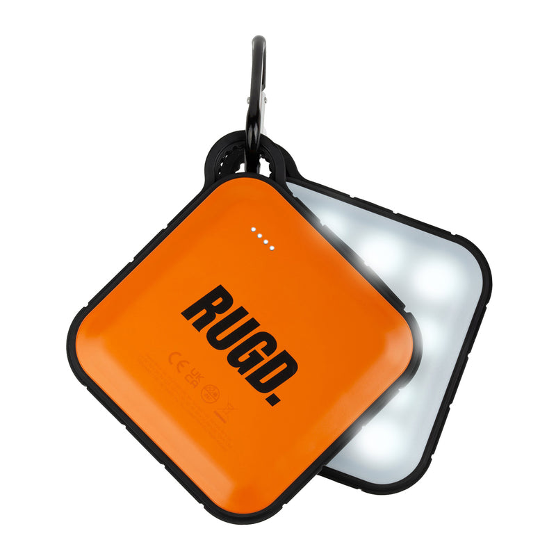 RUGD portable charger hanging from its carabiner and showing the front and back with the camping light lit