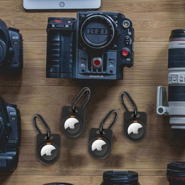 Army Air Tag Case displayed alongside professional camera gear, showcasing its suitability for camping accessories and valuable equipment.