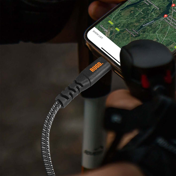 Rugged MFi to USB-C charging cable connected to a smartphone with a navigation app running