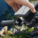 Rhino Power Lightning MFi to USB-C Charging Cable connected to a smartphone on a bike handlebar, showcasing durability outdoors